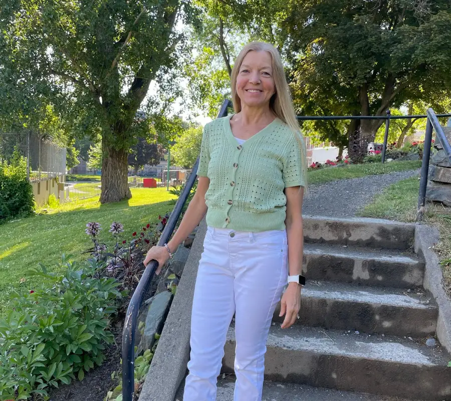 Linda outdoors on garden steps