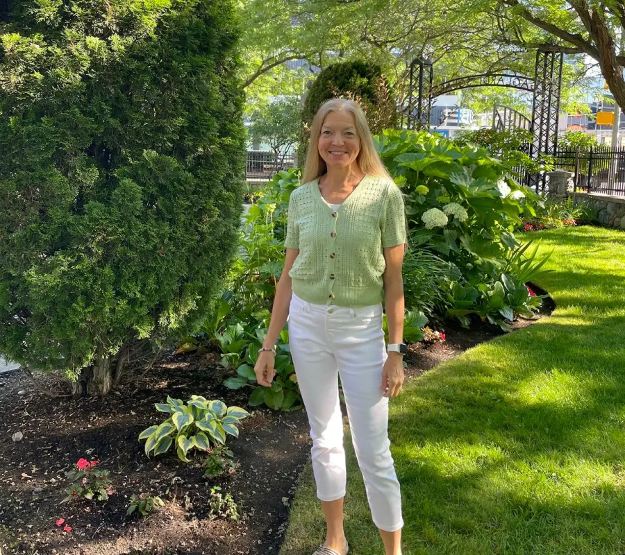 Linda standing in a garden
